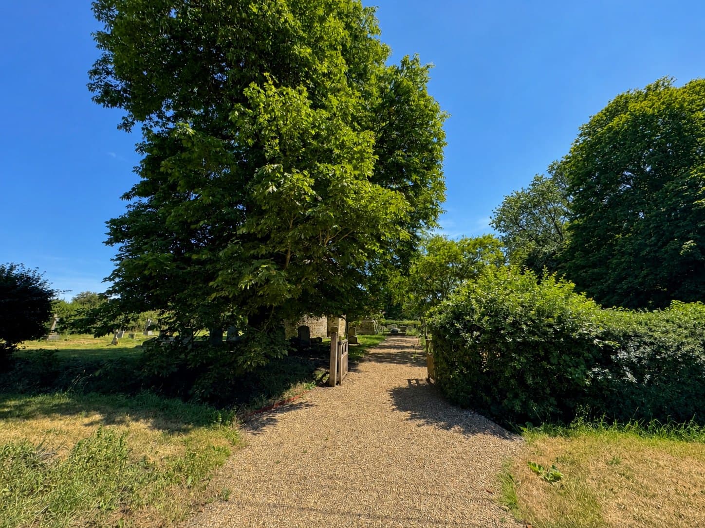 Open path leading into the churchyard at All Saints Little Bradley.